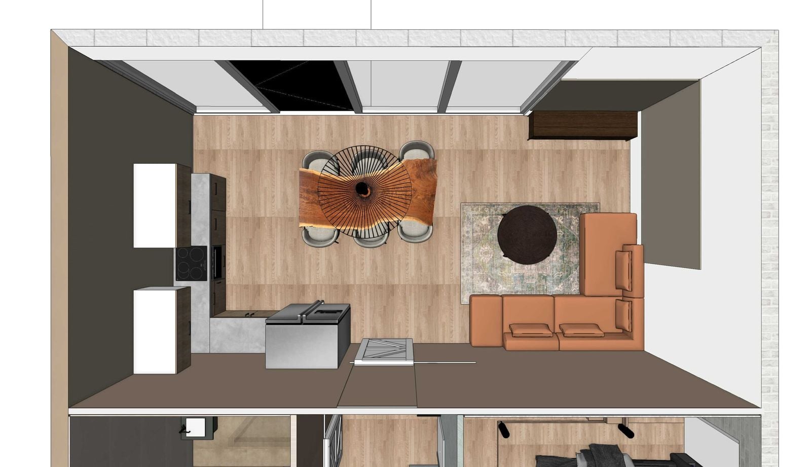Bovenaanzicht van de open woonkamer met een houten eettafel met boomstamrand, een zwarte waaiervormige hanglamp, zes lichte stoelen, een cognackleurige leren hoekbank op een vloerkleed en een keuken met kookeiland.